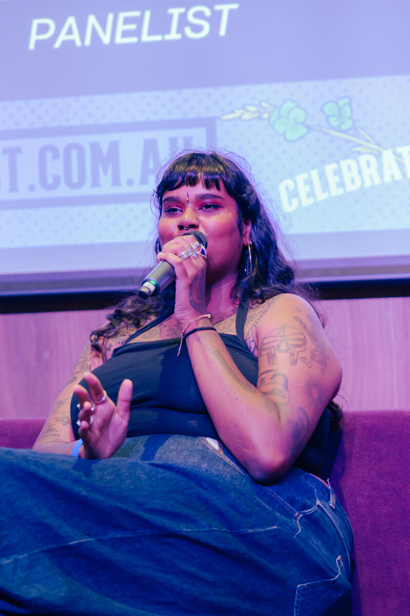 Untitled Woman speaking and holding a microphone
