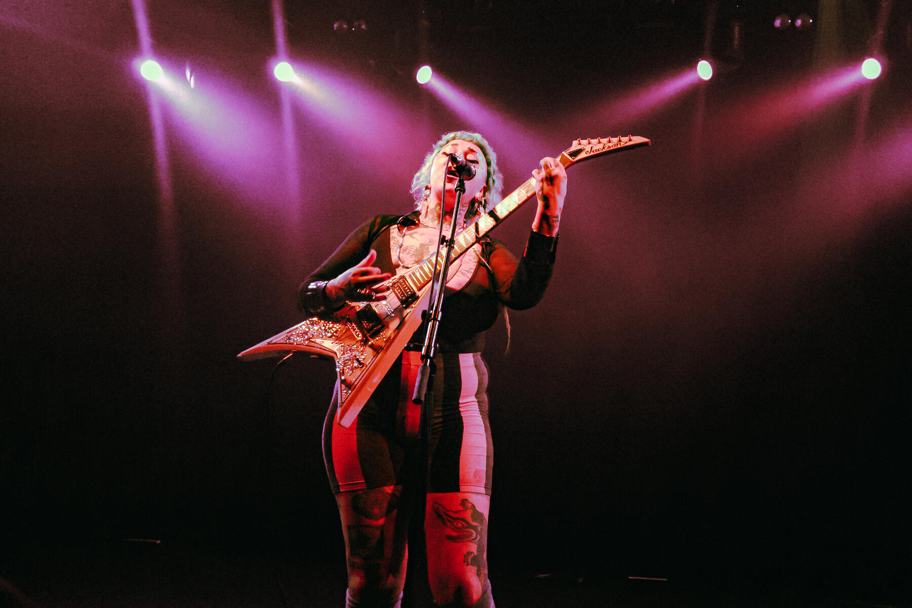 Untitled Female jazz musician singing and playing guitar at a concert