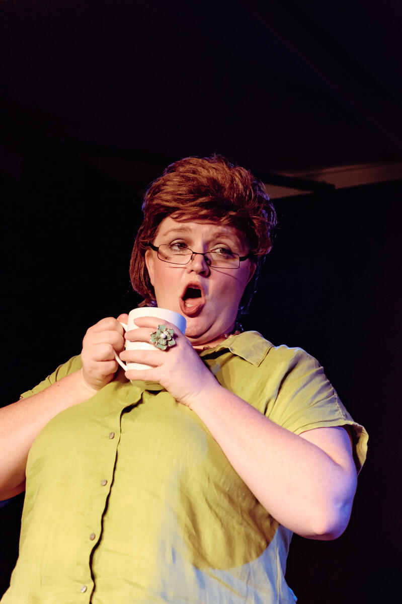 Woman dressed as a 40 year old receptionist for comedy sketch