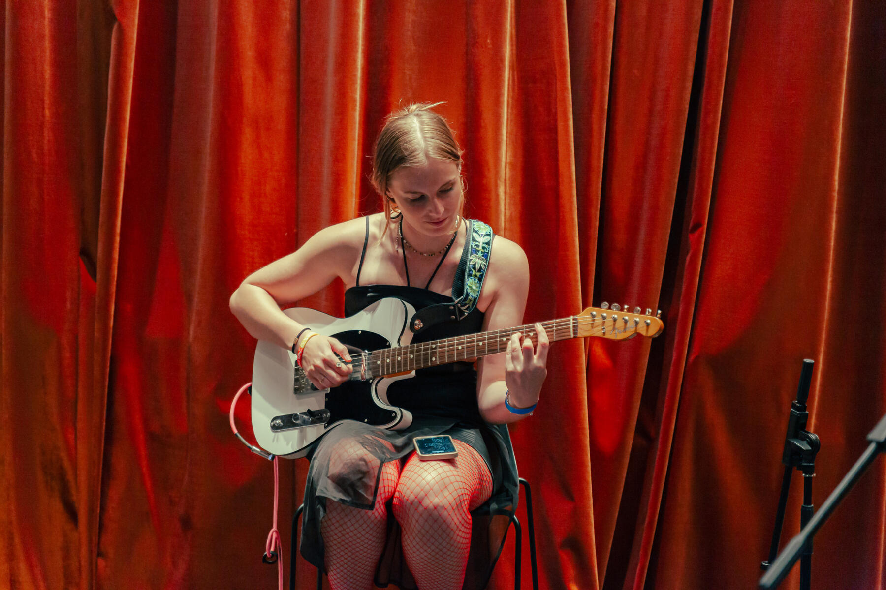 Untitled A female guitarist and singer performing at a panel event