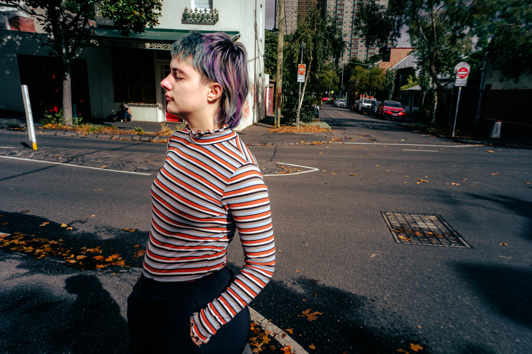 Editorial-style image of a person standing in the street