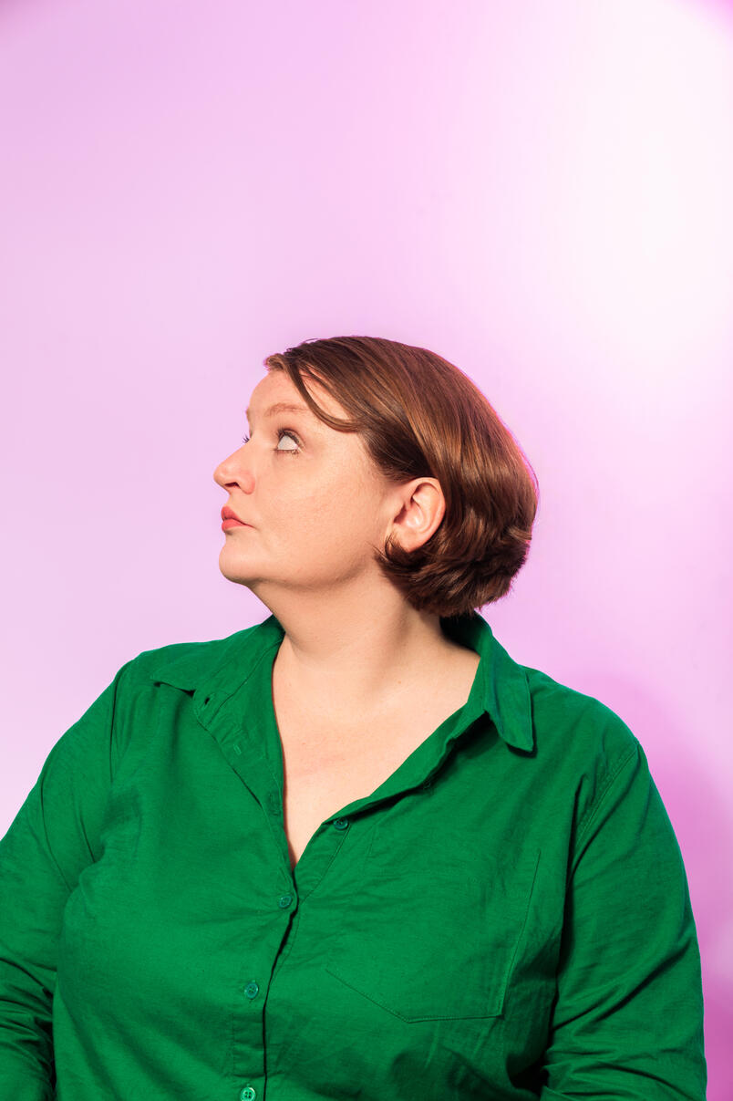 Woman in front of purple background